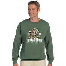 Load image into Gallery viewer, A man wearing a sage green crewneck sweatshirt with a graphic of a dog in a Santa hat holding a drink, with the text 'NOLLAIG SHONA & SLáINTE', against a plain white background.